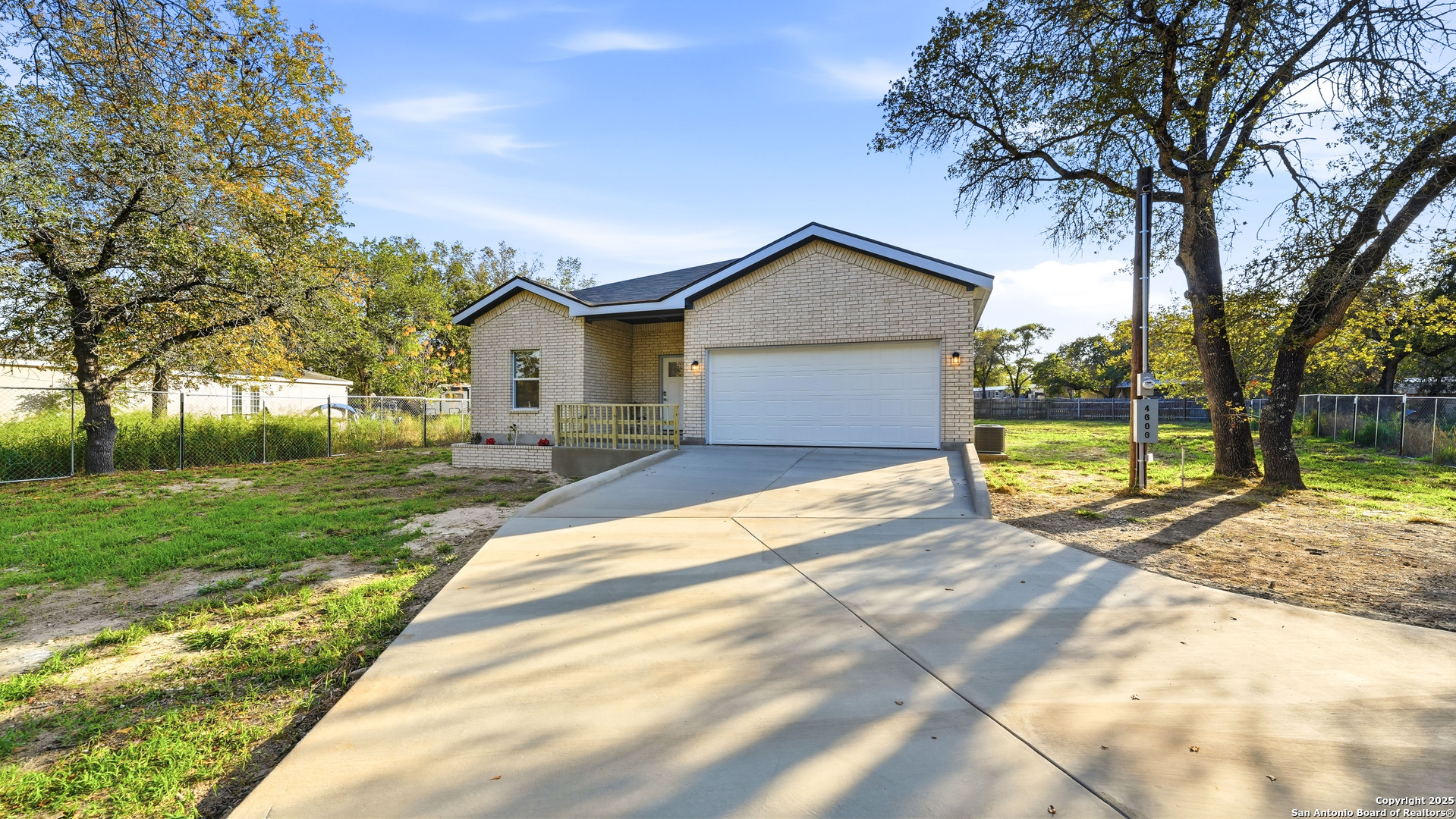 4606 Lee Way Elmendorf, TX 78112 - Photo 2 of 45 a view of a house with a yard and large tree