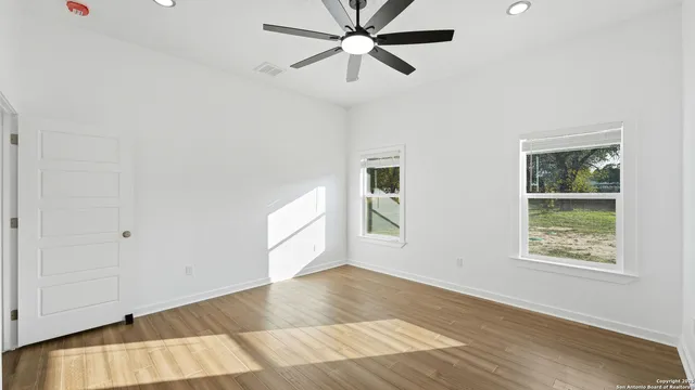 wooden floor in an empty room with a window