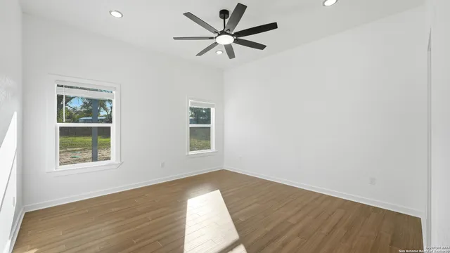 wooden floor in an empty room with a window