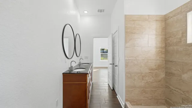 a view of a room with wooden floor