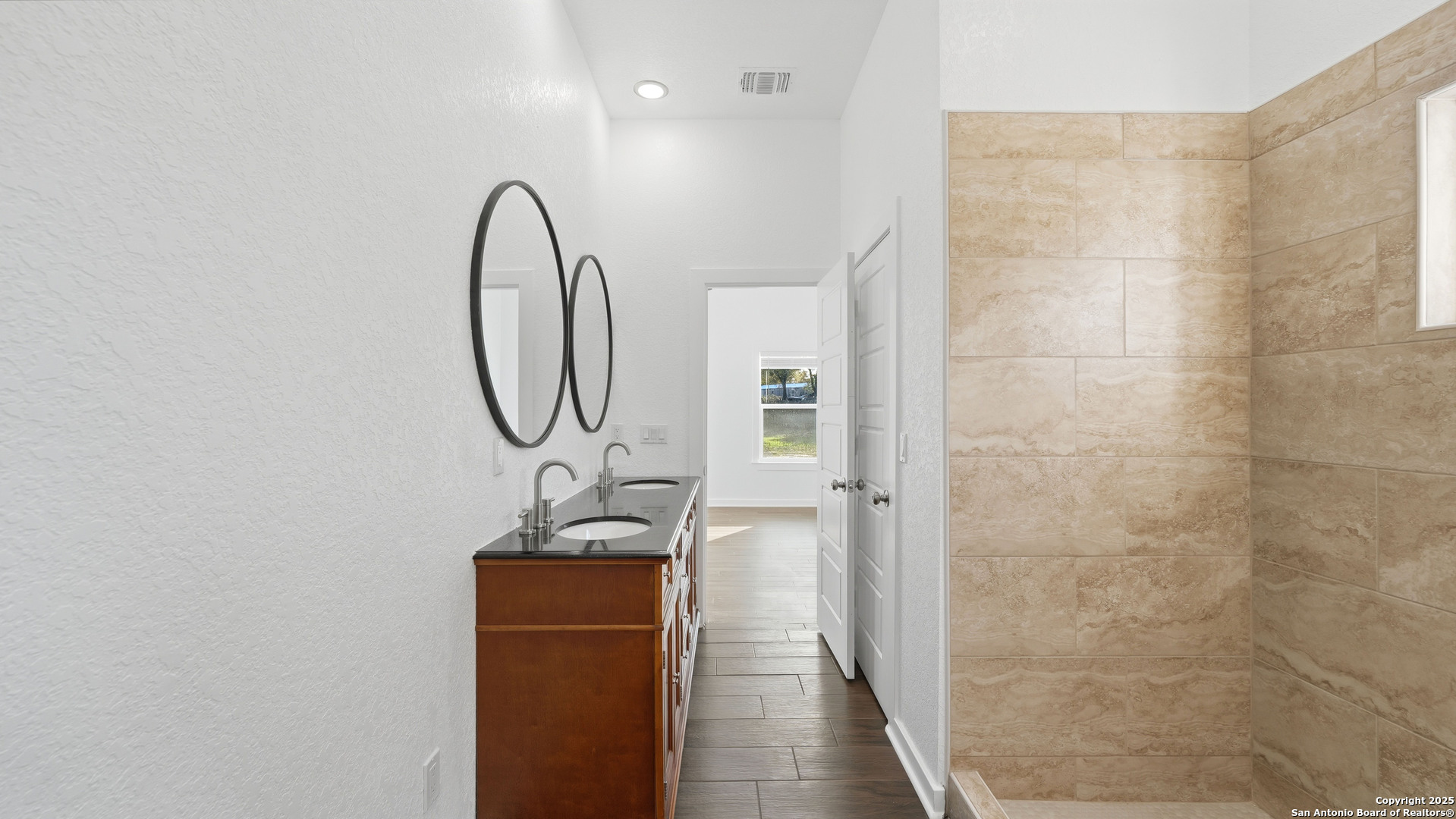 4606 Lee Way Elmendorf, TX 78112 - Photo 26 of 45 a picture of a mirror of a bathroom