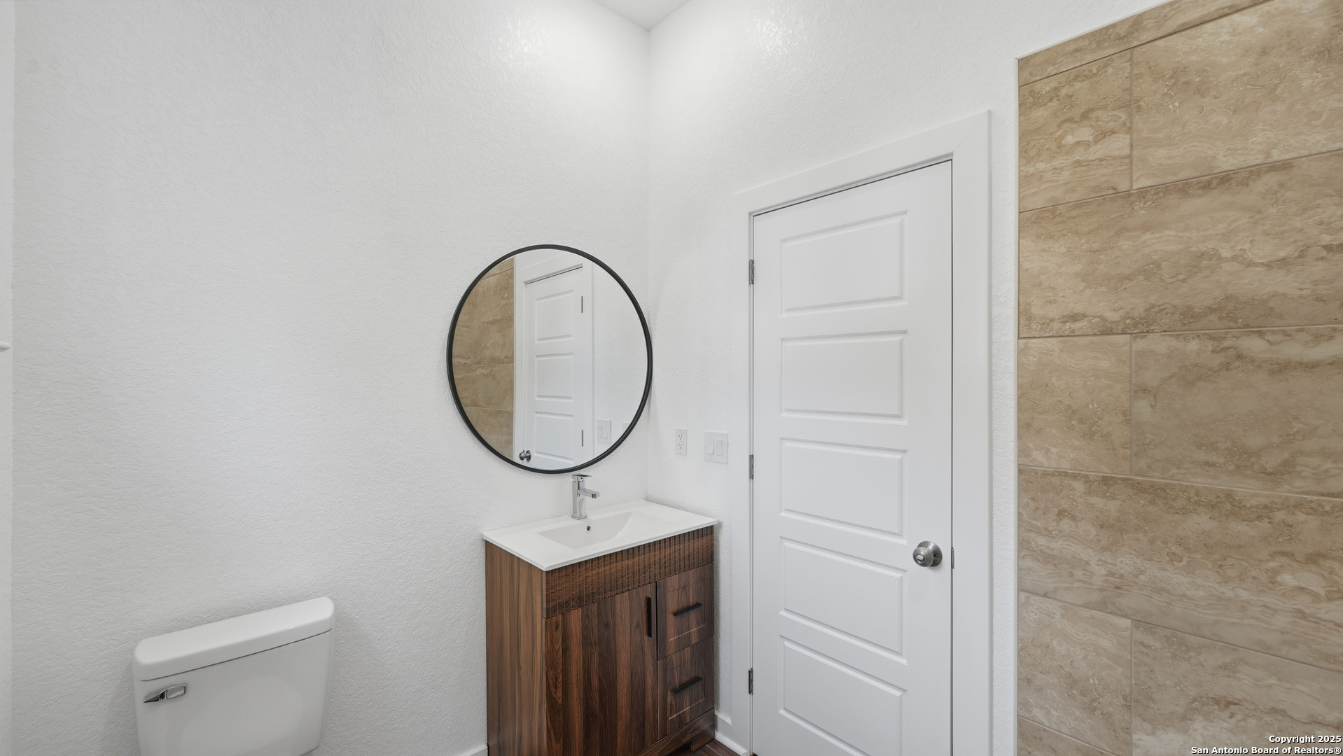 4606 Lee Way Elmendorf, TX 78112 - Photo 34 of 45 a bathroom with a sink a toilet and a mirror