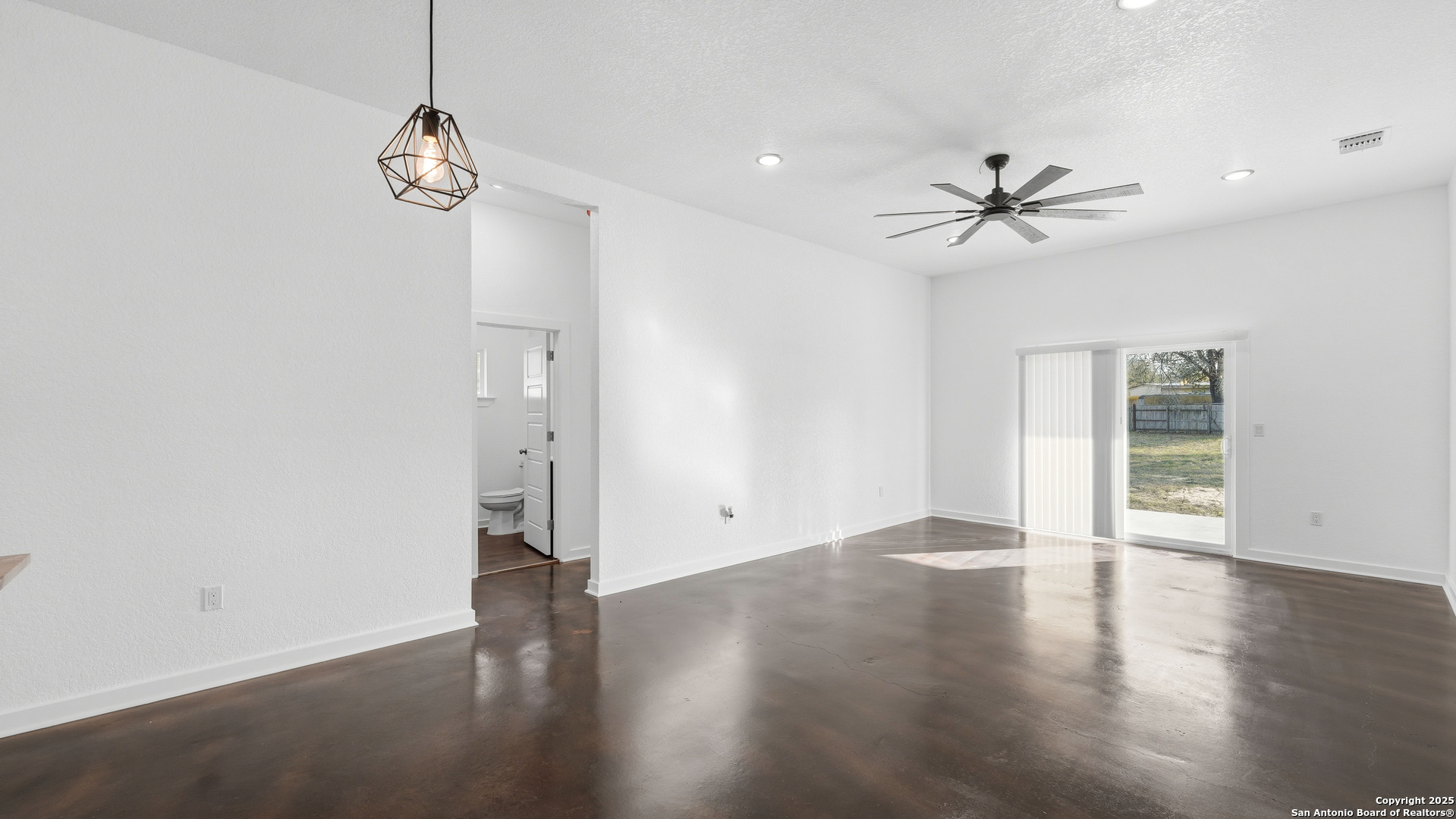 4606 Lee Way Elmendorf, TX 78112 - Photo 8 of 45 a view of empty room with wooden floor and ceiling fan