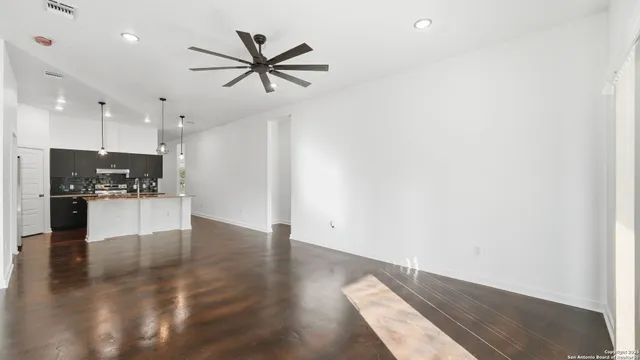 a kitchen with a sink a refrigerator and chandelier