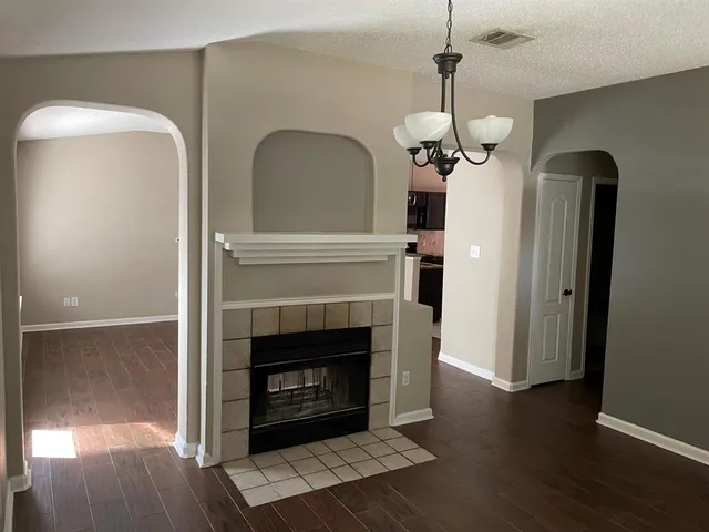a living room with wooden floor a fireplace