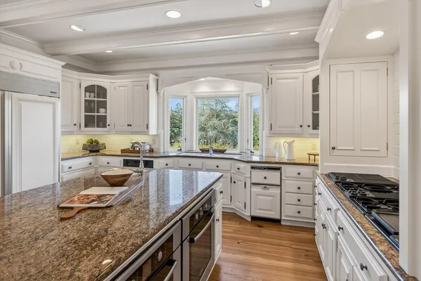 a kitchen with a stove a sink and a refrigerator