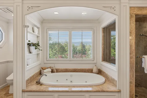 a bathroom with a tub and a window