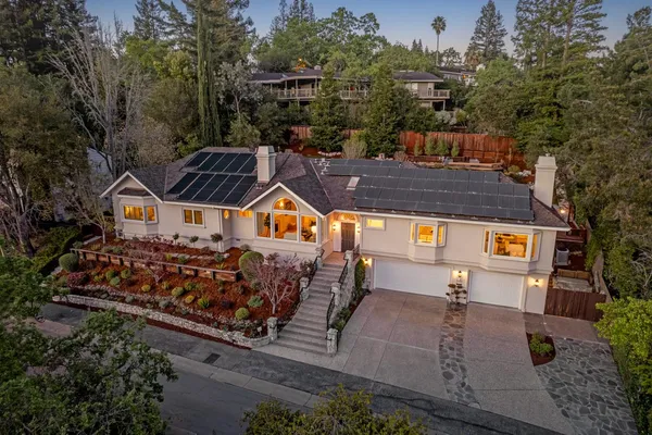 an aerial view of a house with garden space and street view