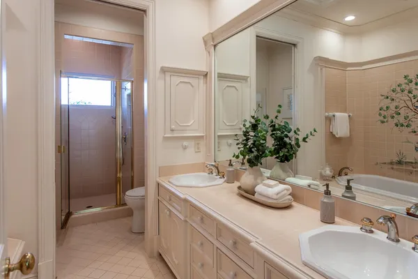 a bathroom with a double vanity sink mirror and toilet
