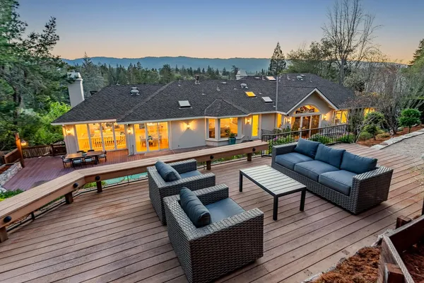 an outdoor sitting area with couch and wooden floor