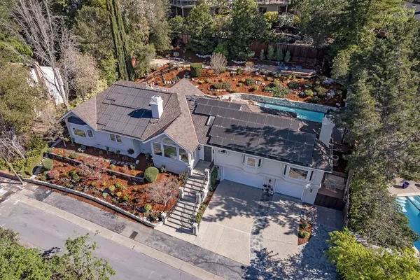 a view of a chairs and table in the backyard
