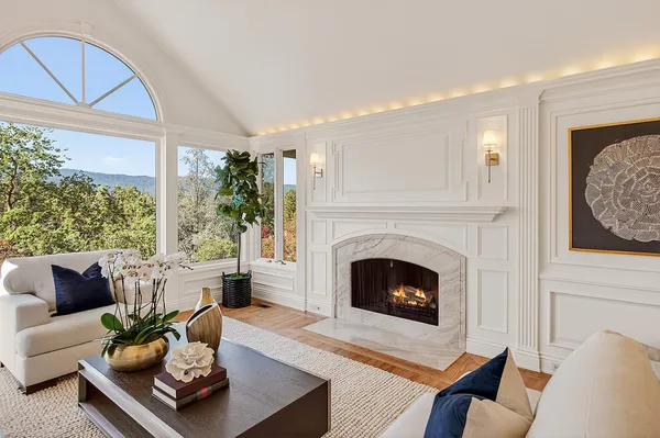 a living room with furniture fireplace and window