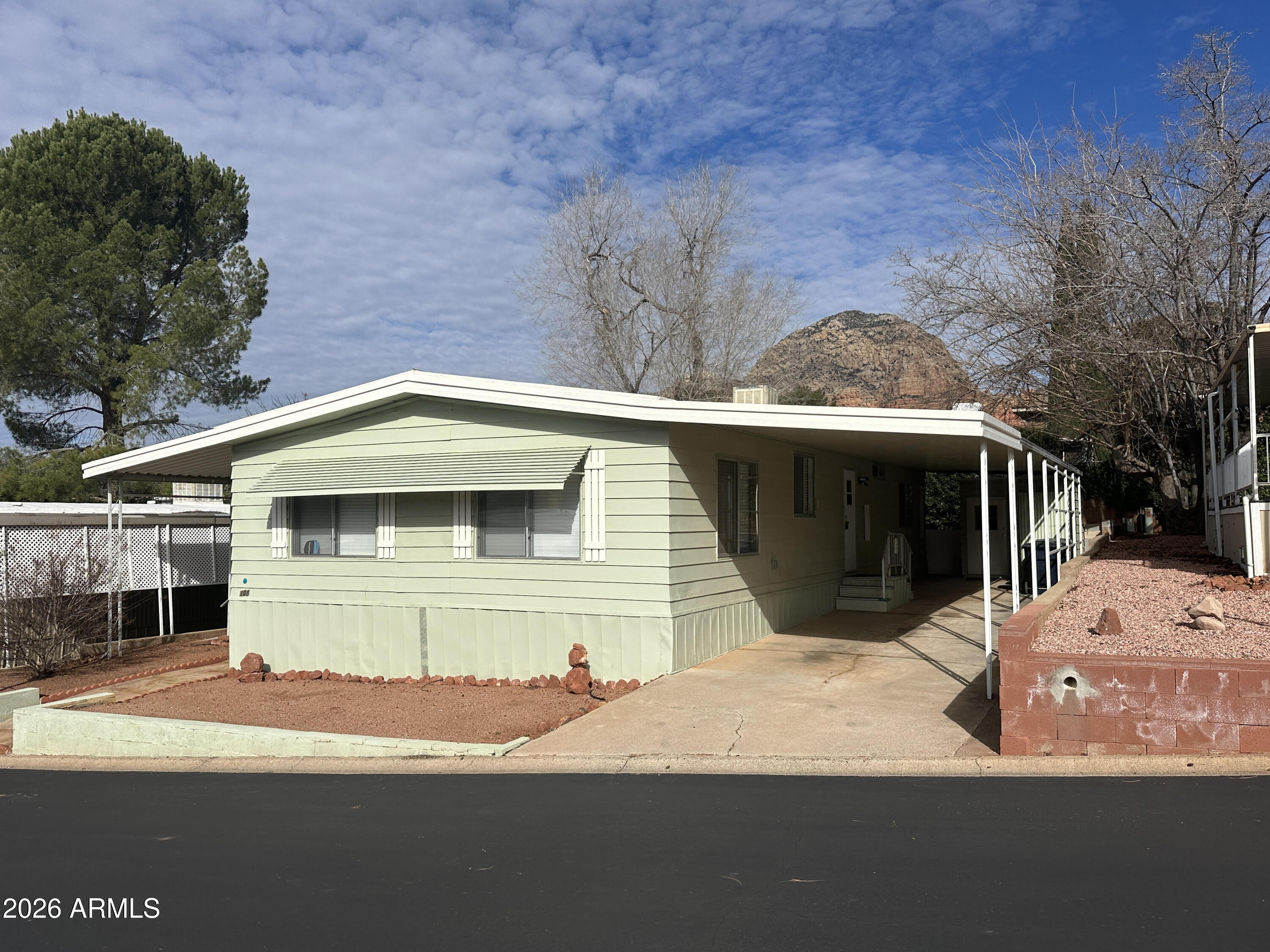 205 Sunset Drive, Unit 108 Sedona, AZ 86336 - Photo 1 of 16 a front view of a house with a yard