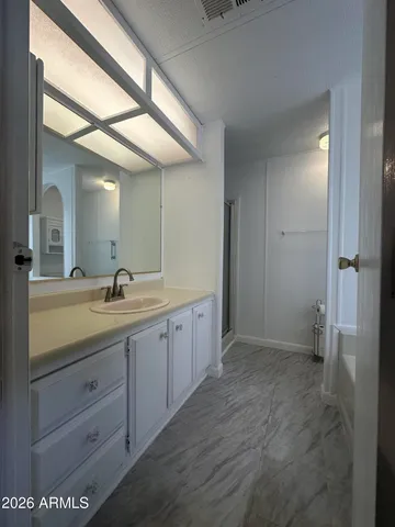 a spacious bathroom with a granite countertop sink mirror and a