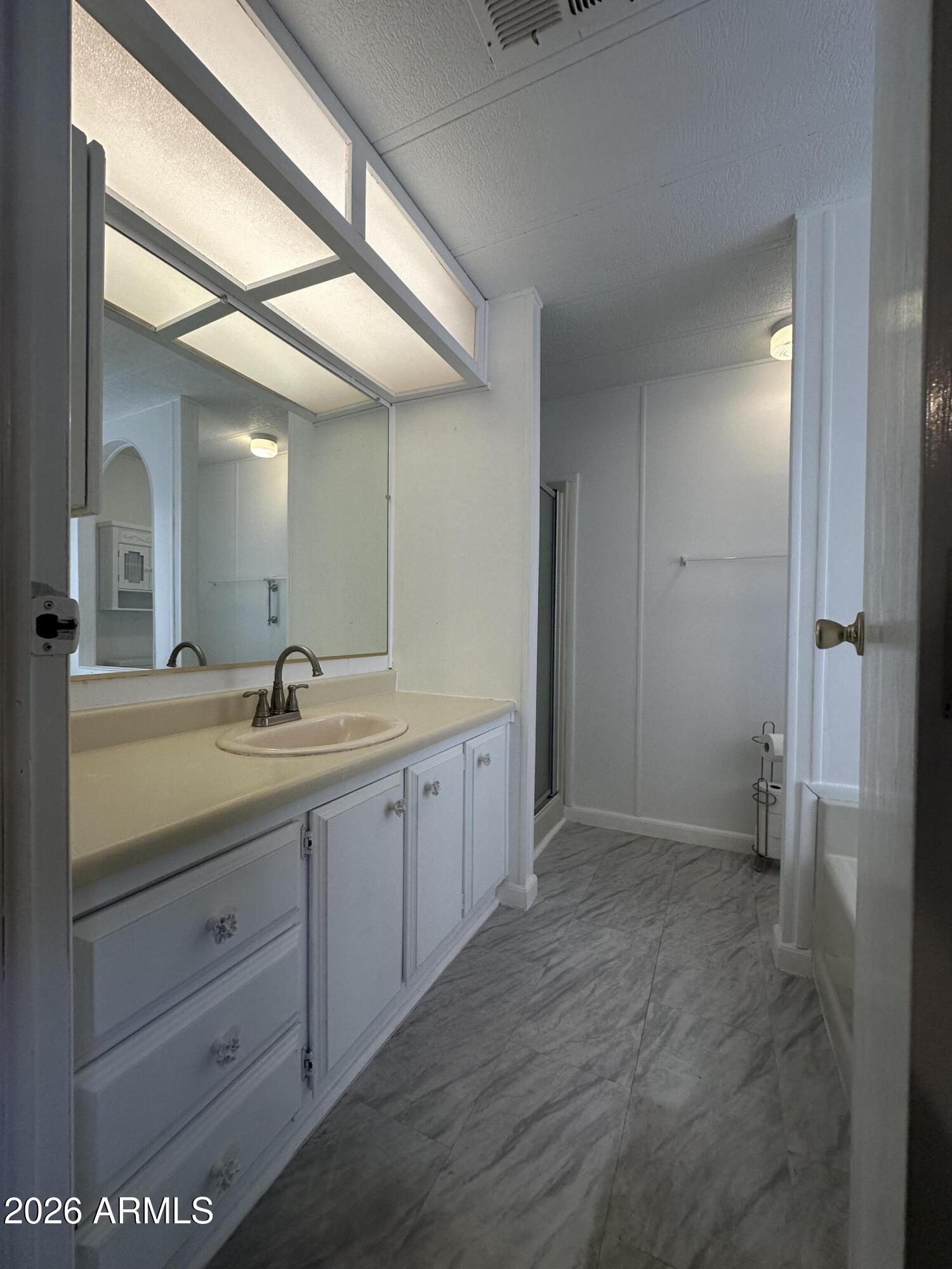 205 Sunset Drive, Unit 108 Sedona, AZ 86336 - Photo 12 of 16 a spacious bathroom with a granite countertop sink mirror and a