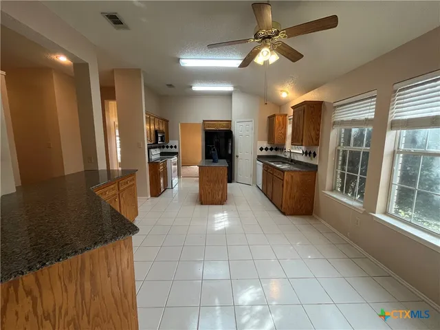 a view of empty room with fireplace