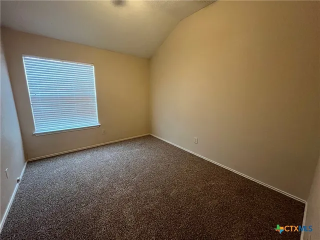 an empty room and a bathroom