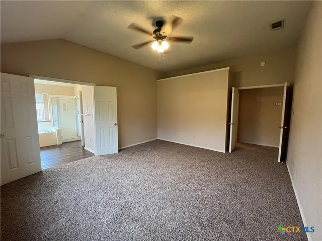 a spacious bathroom with a double vanity sink a mirror and a bathtub