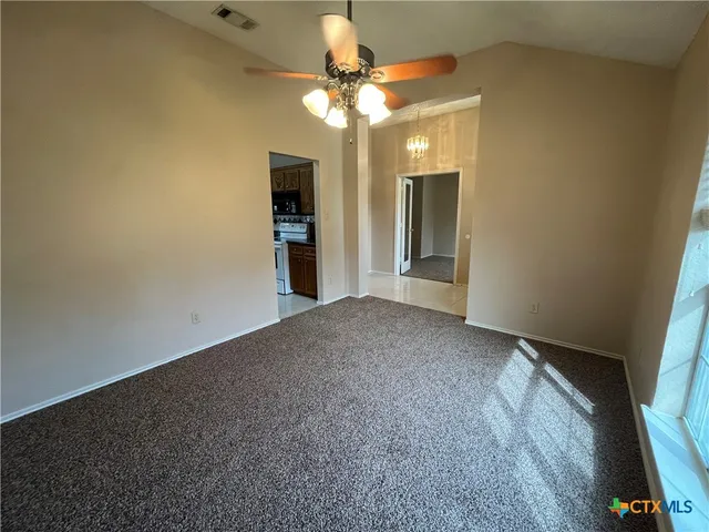 a kitchen with granite countertop a stove a sink and a microwave