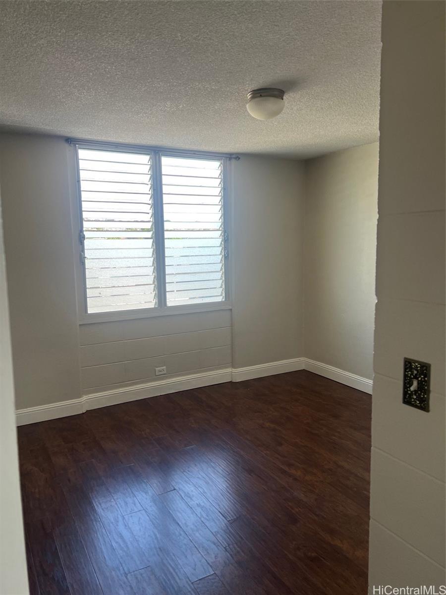 3410 Leahi Avenue, Unit 304 Honolulu, HI 96815 - Photo 14 of 25 an empty room with wooden floor and windows