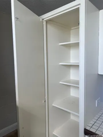 a view of walk in closet with empty racks