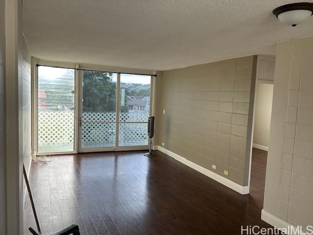 3410 Leahi Avenue, Unit 304 Honolulu, HI 96815 - Photo 7 of 25 an empty room with wooden floor and windows