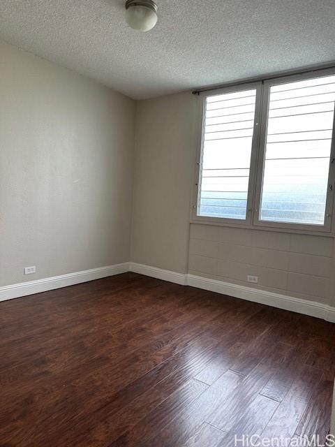3410 Leahi Avenue, Unit 304 Honolulu, HI 96815 - Photo 9 of 25 an empty room with wooden floor and windows