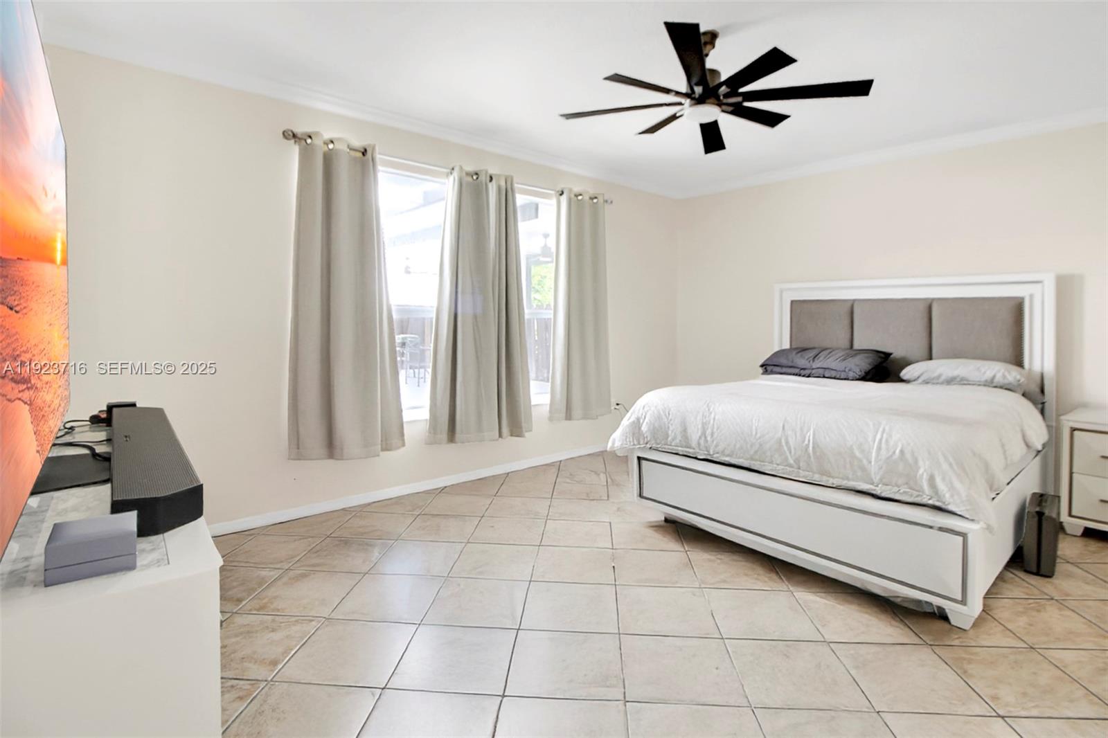 15875 Southwest 149th Lane Miami, FL 33196 - Photo 11 of 32 a bedroom with a bed and a large window