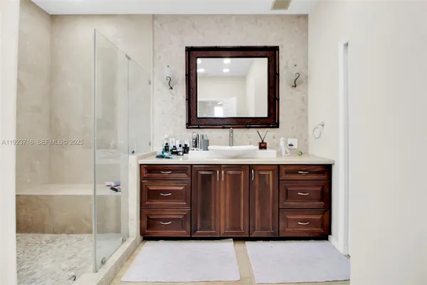 a bathroom with a sink vanity and a mirror