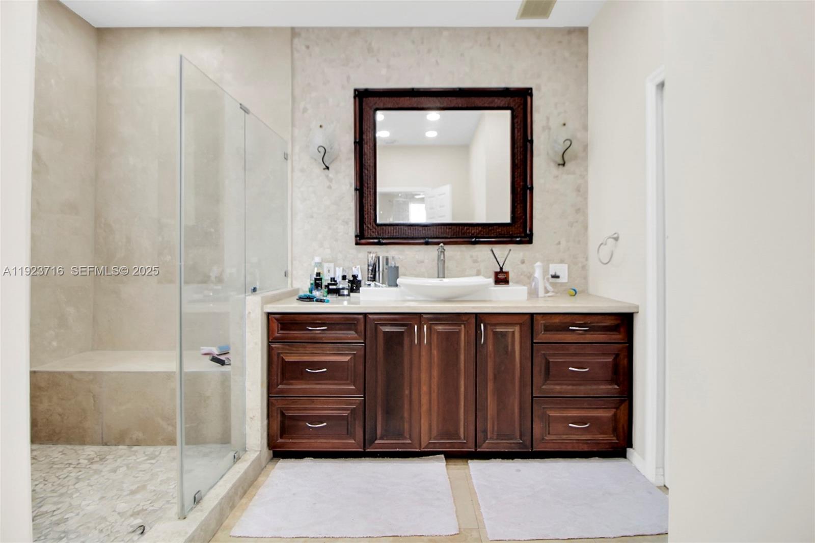 15875 Southwest 149th Lane Miami, FL 33196 - Photo 13 of 32 a bathroom with a sink vanity and a mirror
