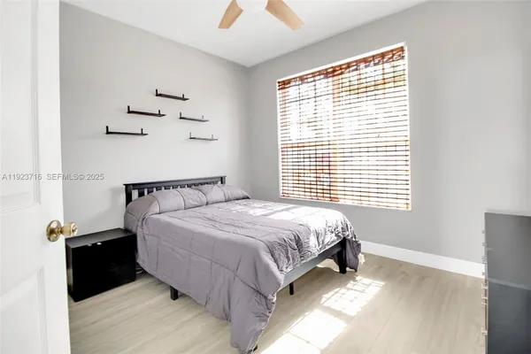 a bed sitting in a bedroom next to a window