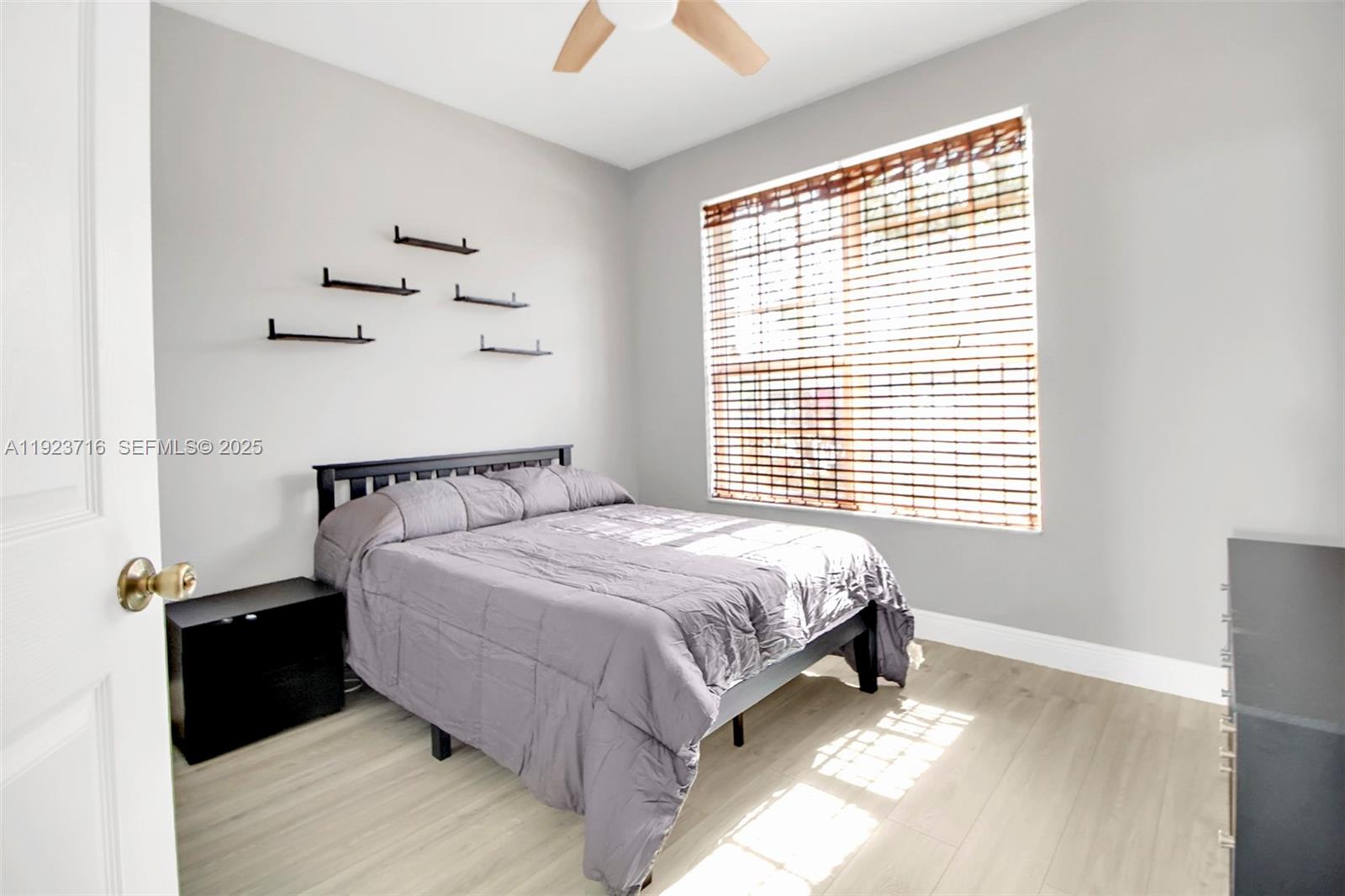 15875 Southwest 149th Lane Miami, FL 33196 - Photo 16 of 32 a bed sitting in a bedroom next to a window