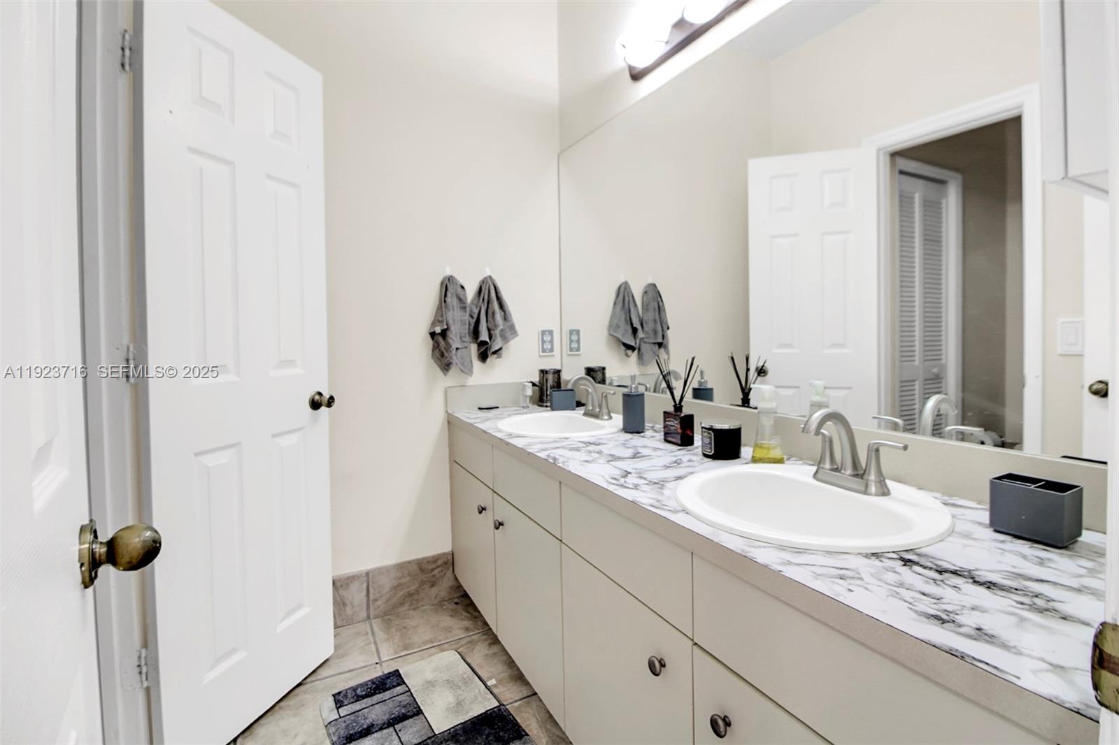 15875 Southwest 149th Lane Miami, FL 33196 - Photo 18 of 32 a bathroom with double sink and a mirror