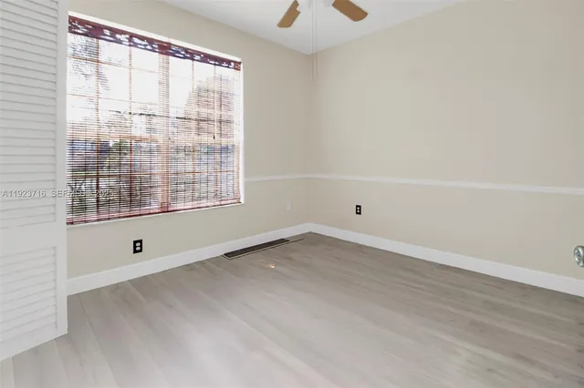 a view of a porch with wooden floor and outdoor seating