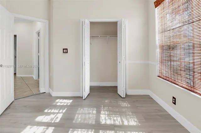 a view of a house with wooden fence