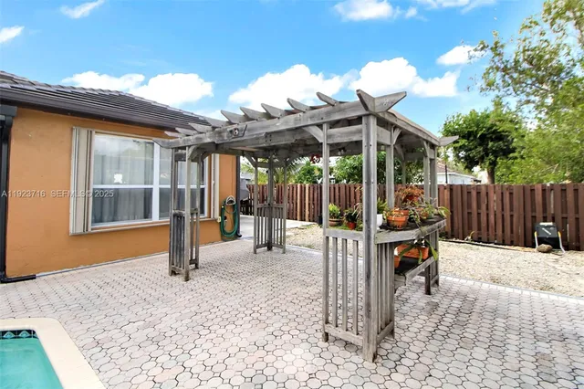 an aerial view of a house with a swimming pool yard and outdoor seating