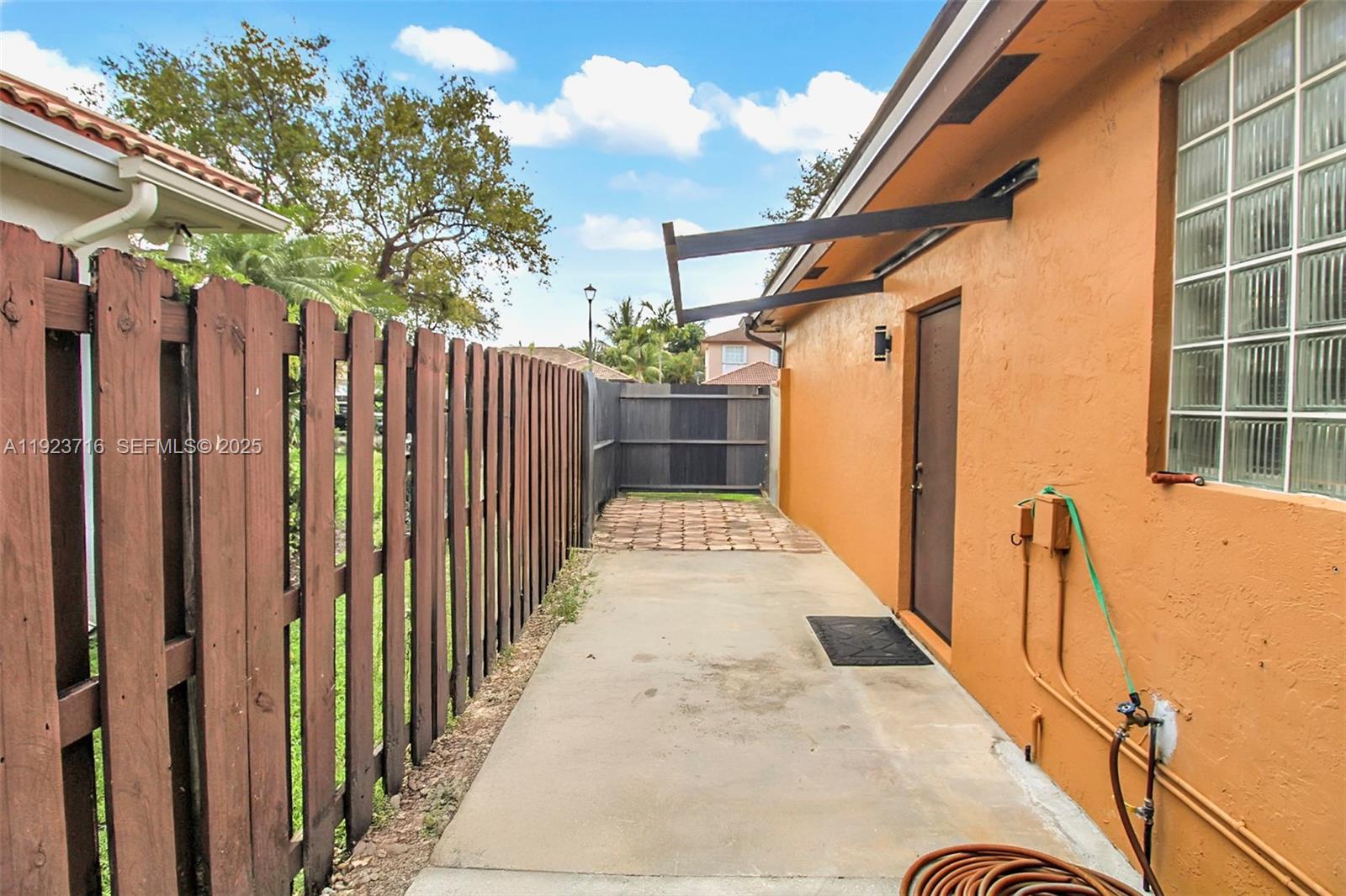 15875 Southwest 149th Lane Miami, FL 33196 - Photo 26 of 32 a view of a house with wooden fence