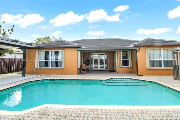 an aerial view of a house with a swimming pool yard and outdoor seating