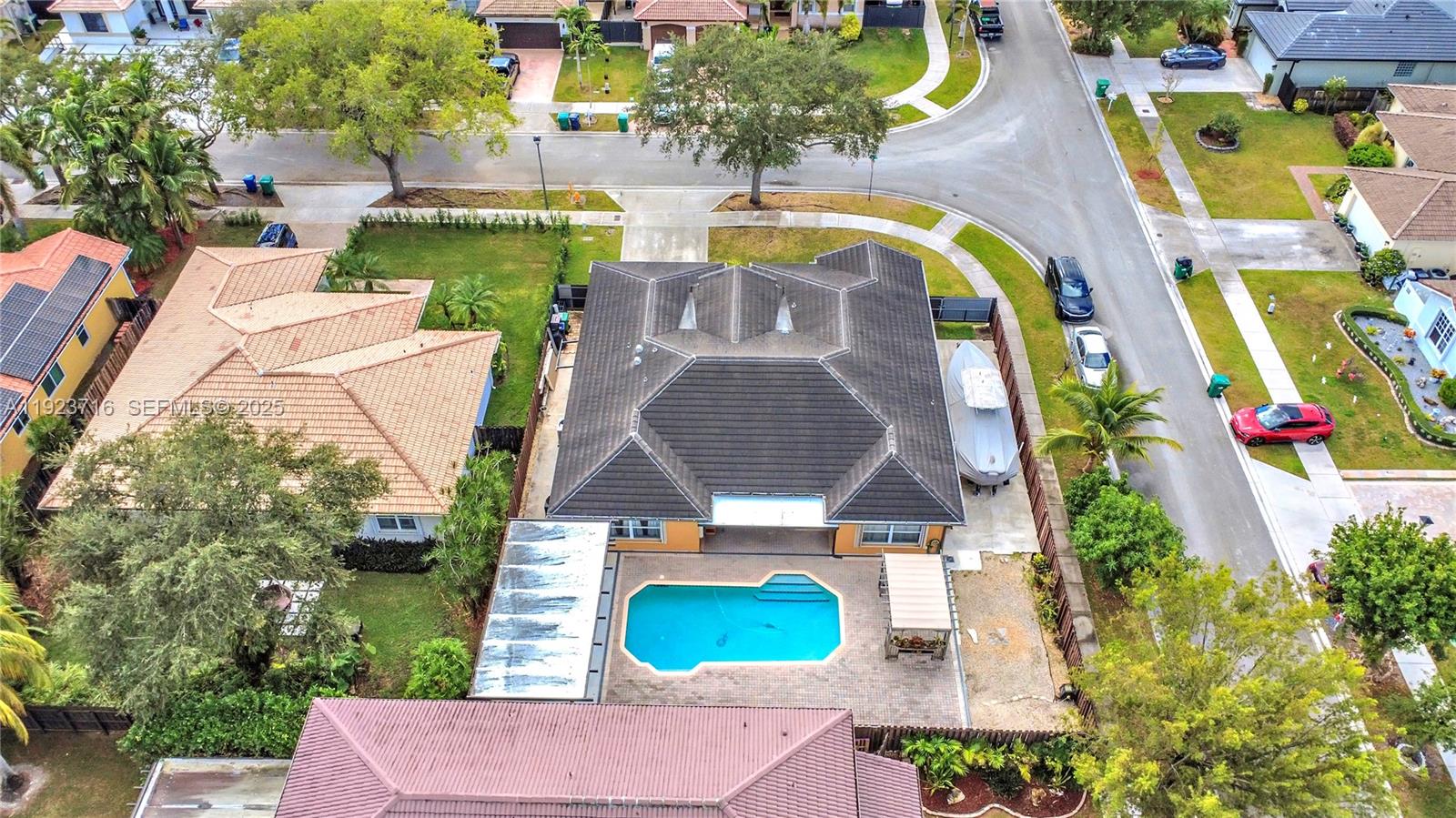 15875 Southwest 149th Lane Miami, FL 33196 - Photo 31 of 32 an aerial view of a swimming pool with a yard and seating area
