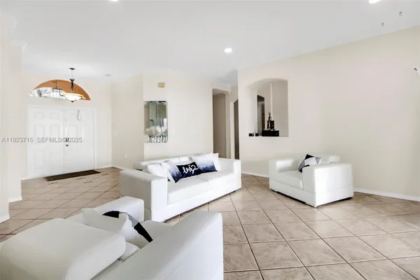a living room with hard wood flooring and a couch