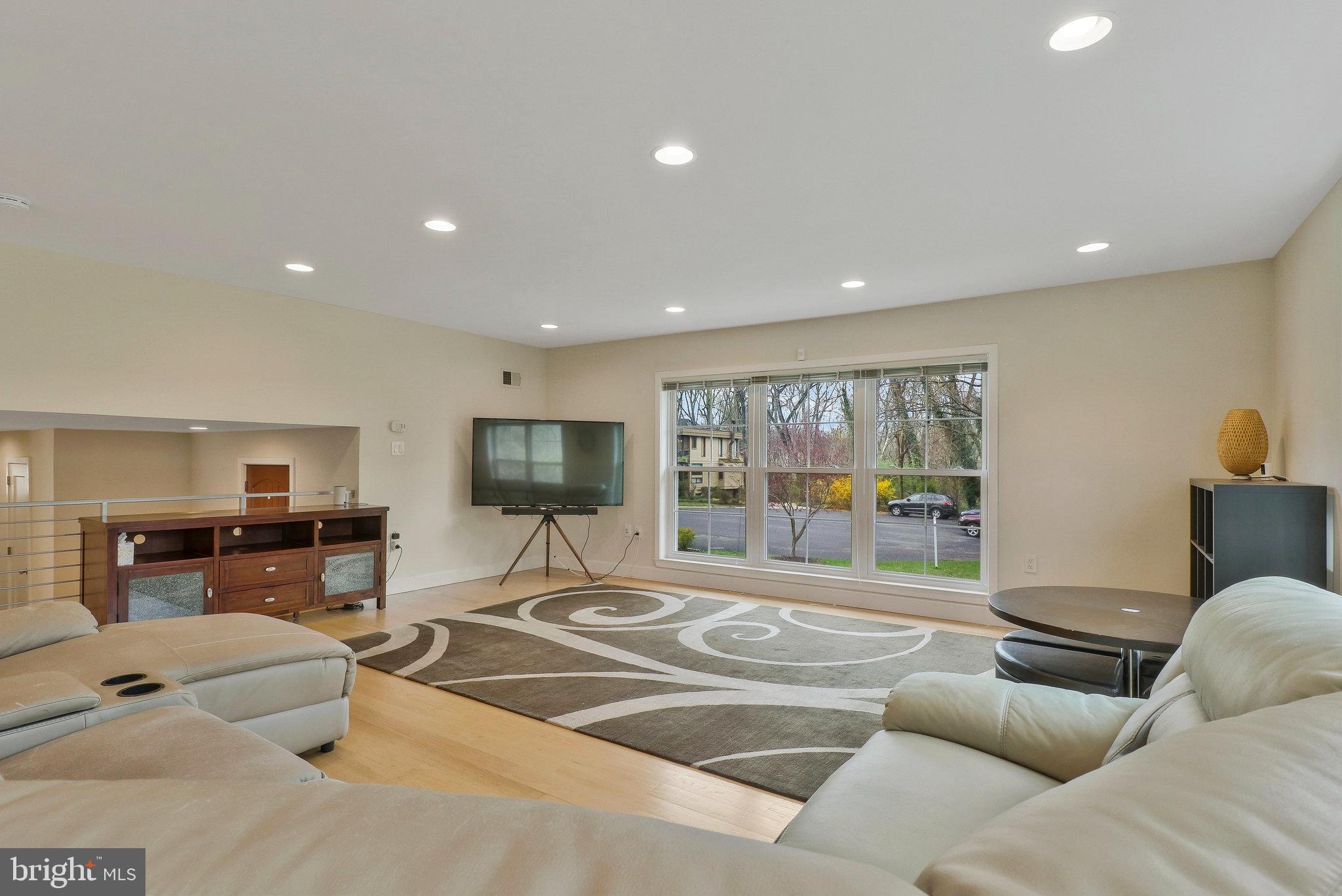 8543 Howell Road Bethesda, MD 20817 - Photo 5 of 24 a living room with furniture and a flat screen tv