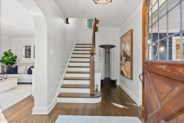 a view of entryway and hall with wooden floor