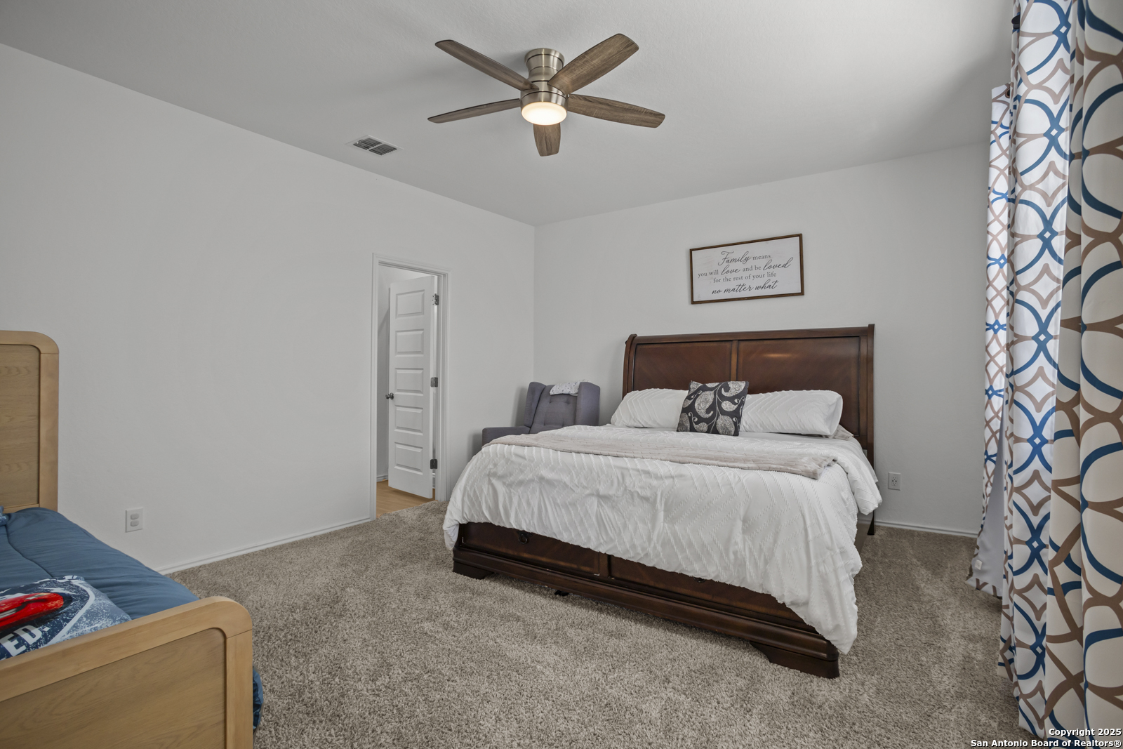 13222 Hagerd Loop St. Hedwig, TX 78152 - Photo 15 of 37 a bedroom with a bed and a chandelier