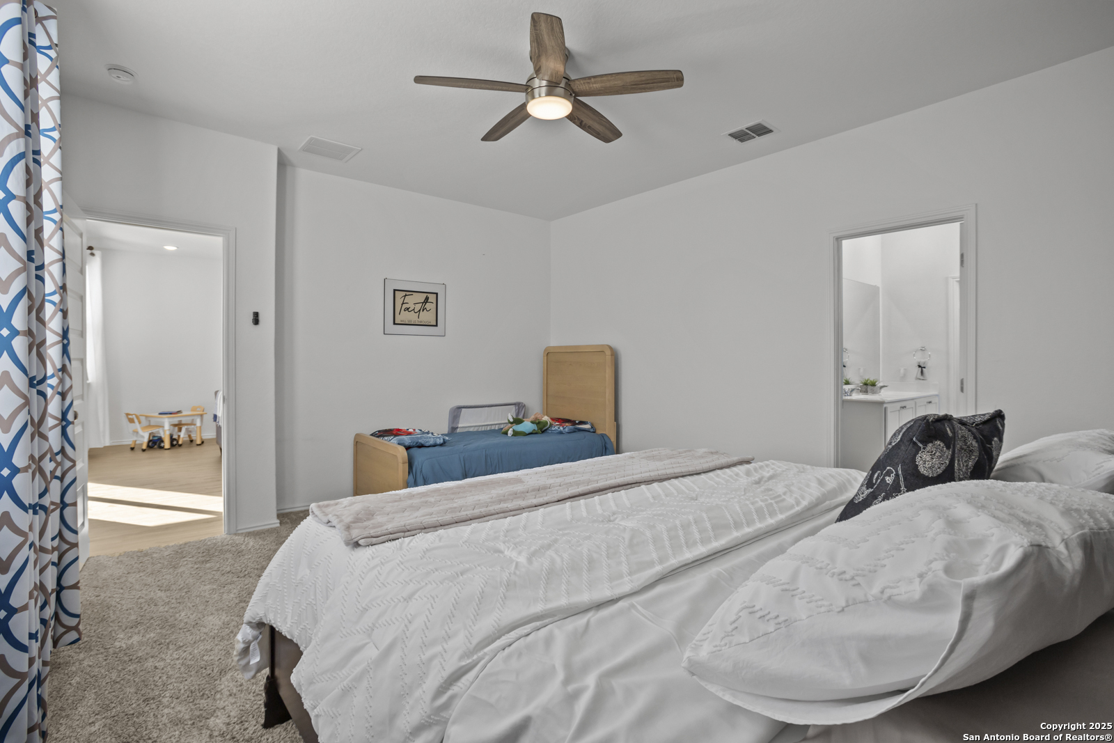 13222 Hagerd Loop St. Hedwig, TX 78152 - Photo 16 of 37 a bedroom with a bed and a chandelier