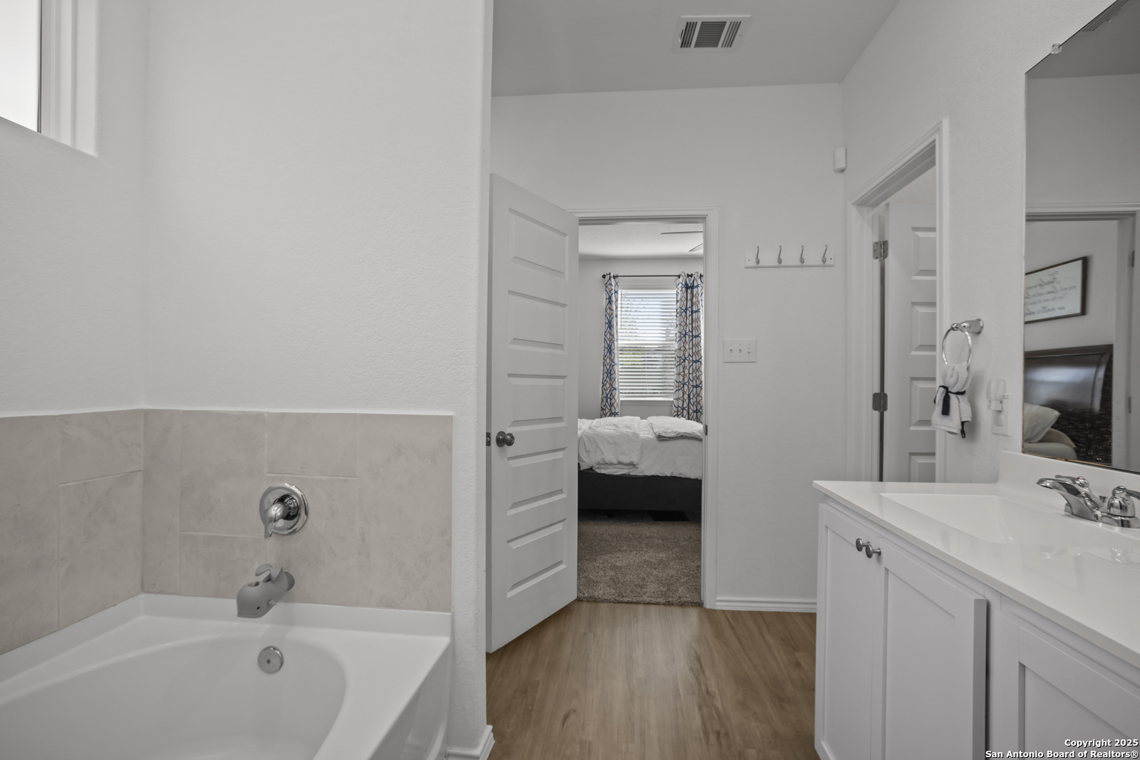 13222 Hagerd Loop St. Hedwig, TX 78152 - Photo 20 of 37 a en suite bathroom with a tub sink and mirror