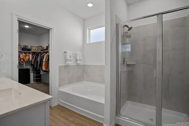 a bathroom with a bathtub and a shower