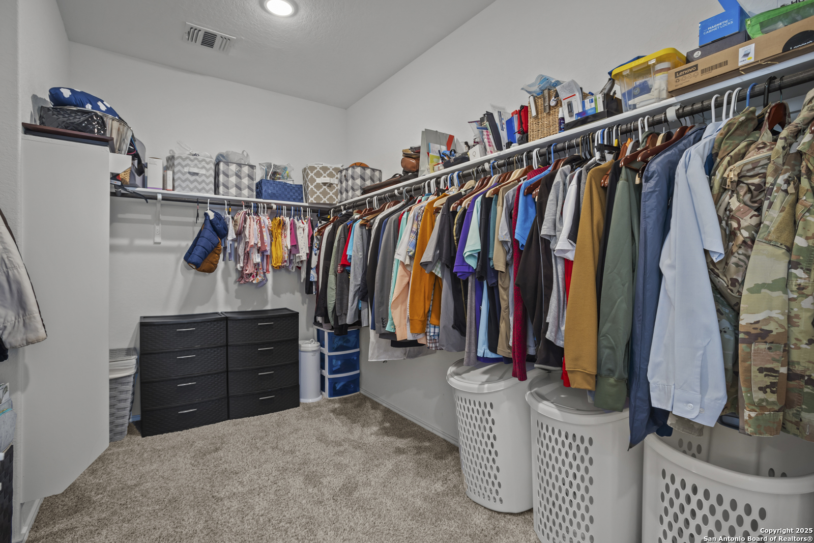 13222 Hagerd Loop St. Hedwig, TX 78152 - Photo 22 of 37 a view of walk in closet with clothes