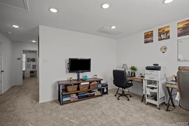 a livingroom with workspace and a couch