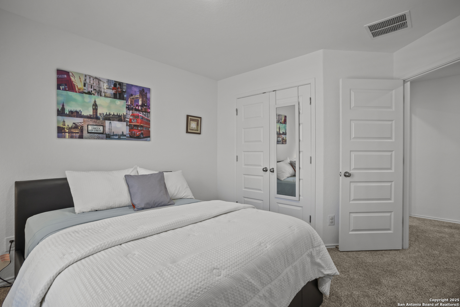 13222 Hagerd Loop St. Hedwig, TX 78152 - Photo 28 of 37 a bedroom with a bed and a painting on the wall