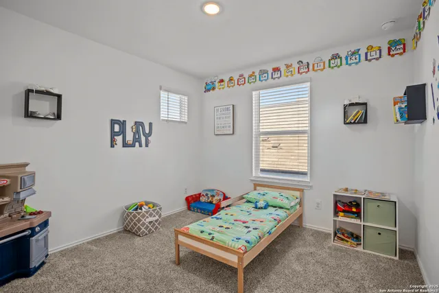 a bedroom with furniture and a window
